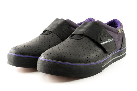 Angled shot of purple casual cycling shoes with reflective heel badge visible
