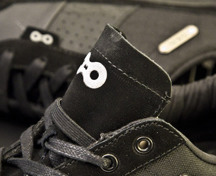 Close-up detail of full-grain leather on black Minna casual cycling shoes