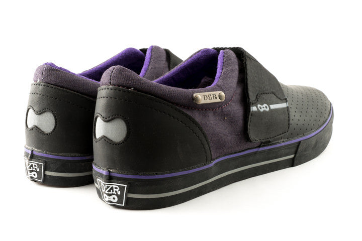 Purp clipless cycling shoes flat lay in studio lighting highlighting outsole tread