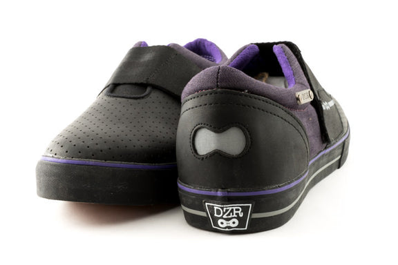 Purple clipless mtb shoes with visible reflective heel badge and flexible shank design