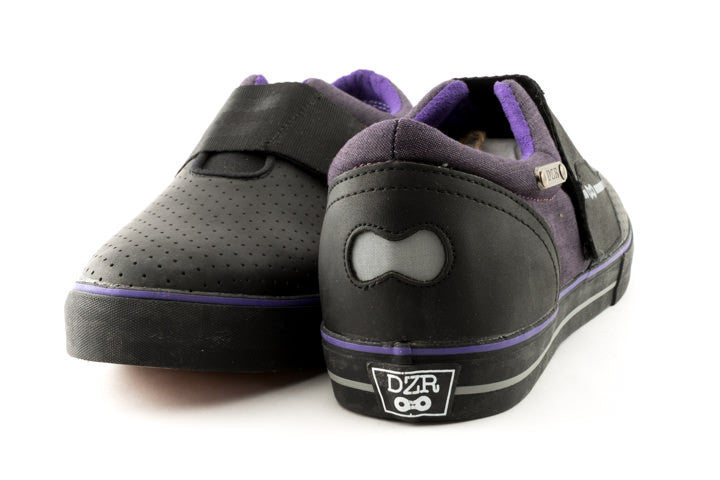 Purple clipless mtb shoes with visible reflective heel badge and flexible shank design
