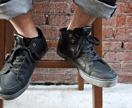 On-foot shot of black H2O waterproof mtb cycling shoes in urban commute style