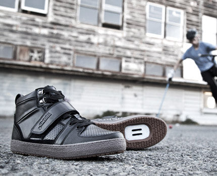 Marco Black clipless cycling shoe, product image on pavement, featuring rugged outdoor shoe design for mountain biking

